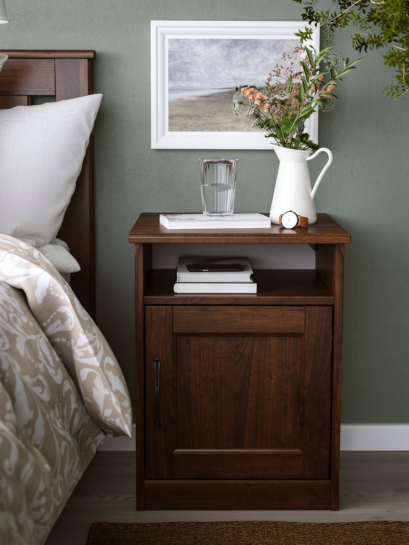 A brown SONGESAND bedside table in the bedroom