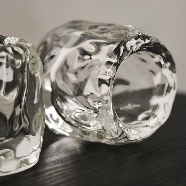 A clear glass STOCKHOLM 2025 tealight holder