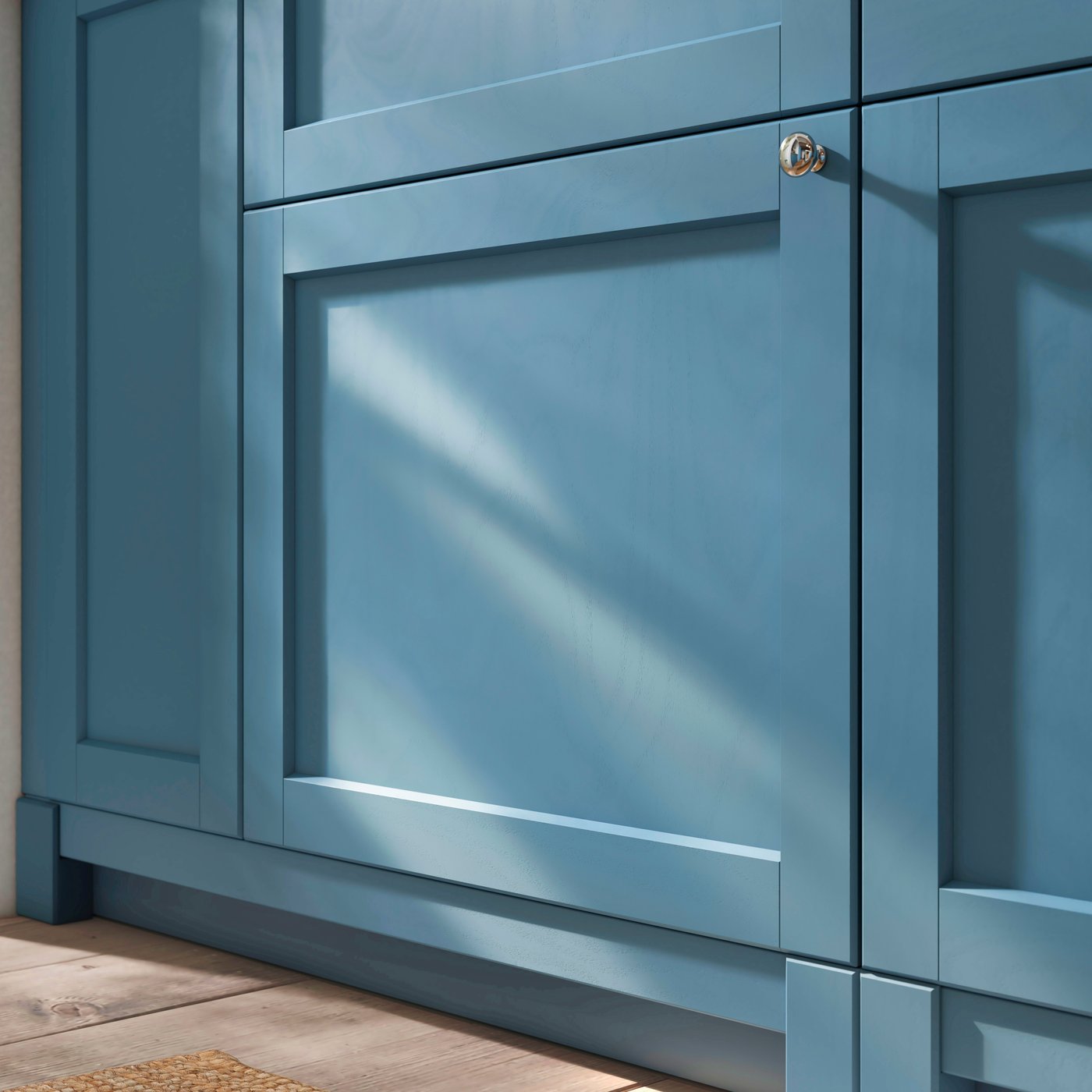 A closeup of SEKTION cabinets with legs and plinths in matching LERHYTTAN blue, offering a crafted and built-in kitchen look.