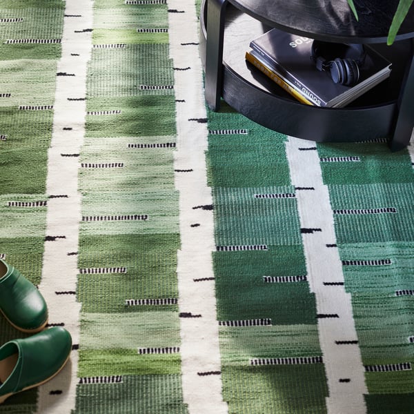 A green/white/black handwoven STOCKHOLM 2025 rug, flatwoven