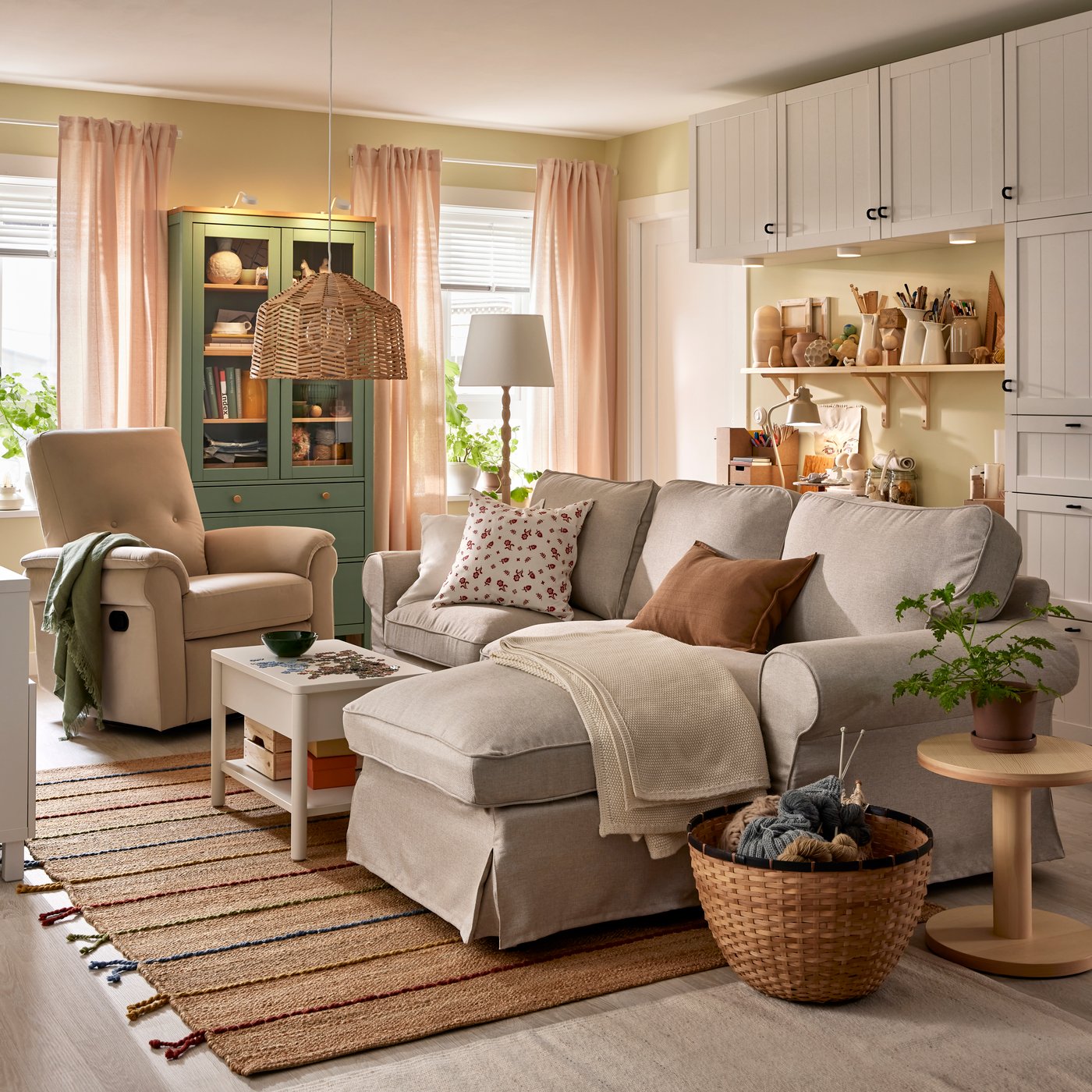 An UPPLAND sofa with chaise longue stands in a functional living room near a HEMNES glass-door cabinet and BESTÅ storage.