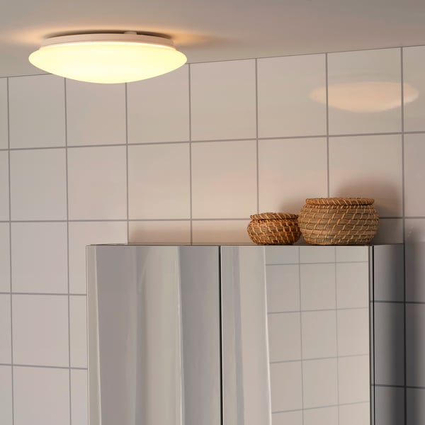 A white BARLAST LED ceiling/wall lamp in a bathroom