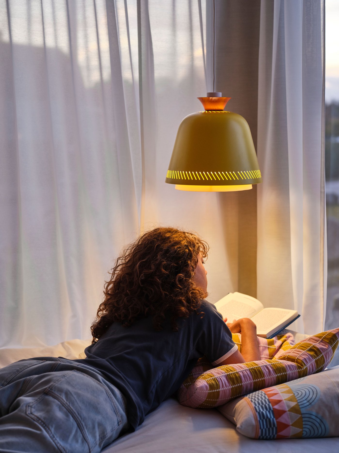A multicolour OMMJÄNGE cushion cover in the bedroom