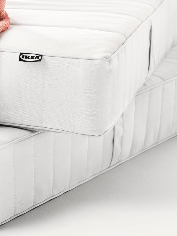 A firm/white ÅNNELAND hybrid mattress