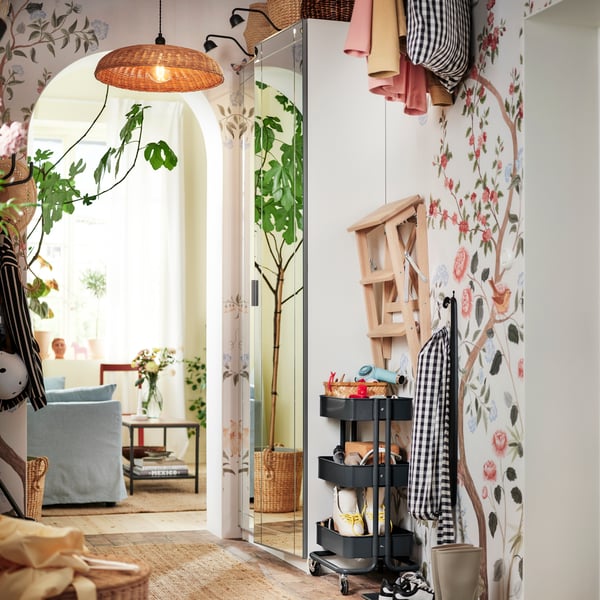 A small hallway with a PAX/KAMMANTORP wardrobe combination, a black RÅSKOG trolley and a step ladder along one side.