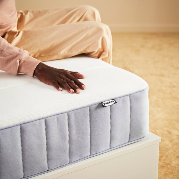 A person lay on a VALEVÅG mattress 
