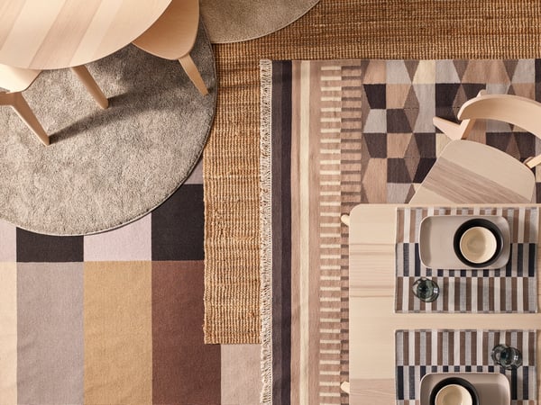 A top-down view of four different textures closely placed together. On the left, there is a dark gray fabric with lighter gray stripes, possibly a woolen material. Adjacent to it on the right is a light-colored fluffy texture that could be a fur or faux fur material.