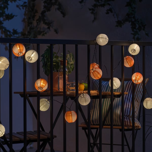 A solar-powered globe/orange pink SOLVINDEN LED lighting chain with 24 lights
