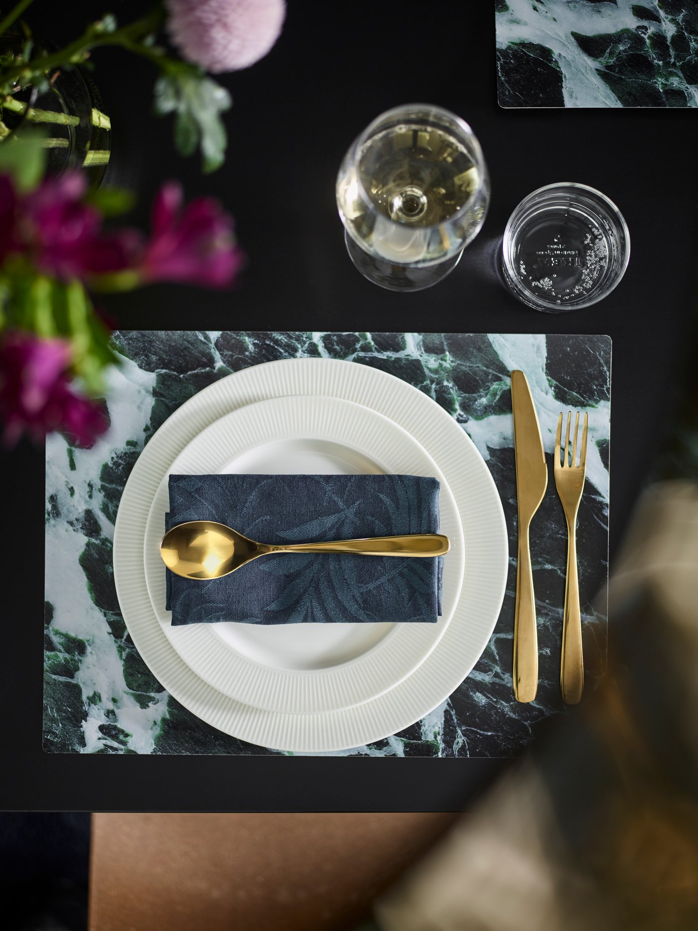 A brass-colour TILLAGD 24-piece cutlery set in the dining room