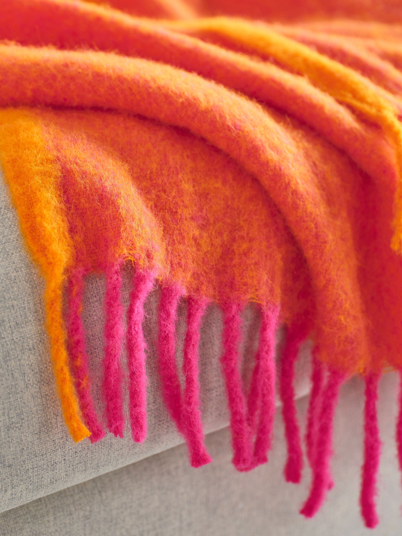 An orange/bright pink KLIPPOXEL throw