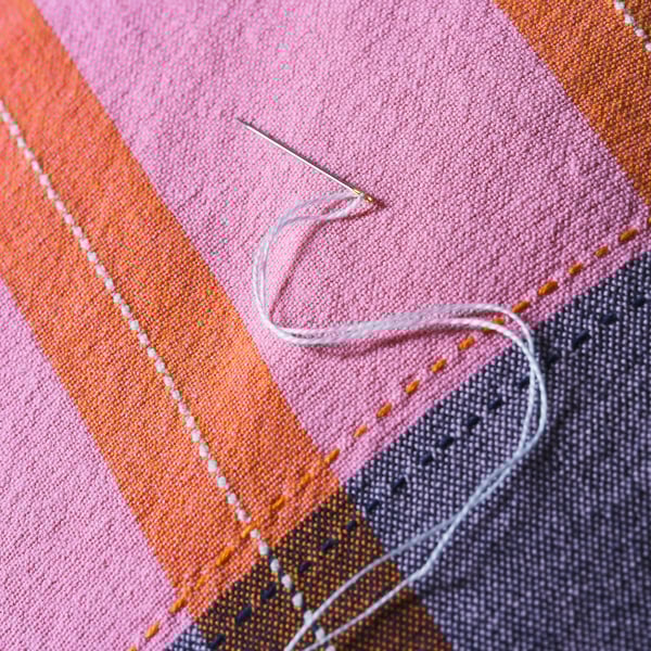 A pink/orange MÄVINN cushion cover