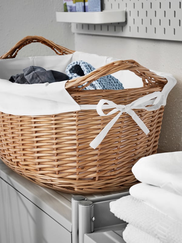 A handmade willow TOLKNING laundry basket