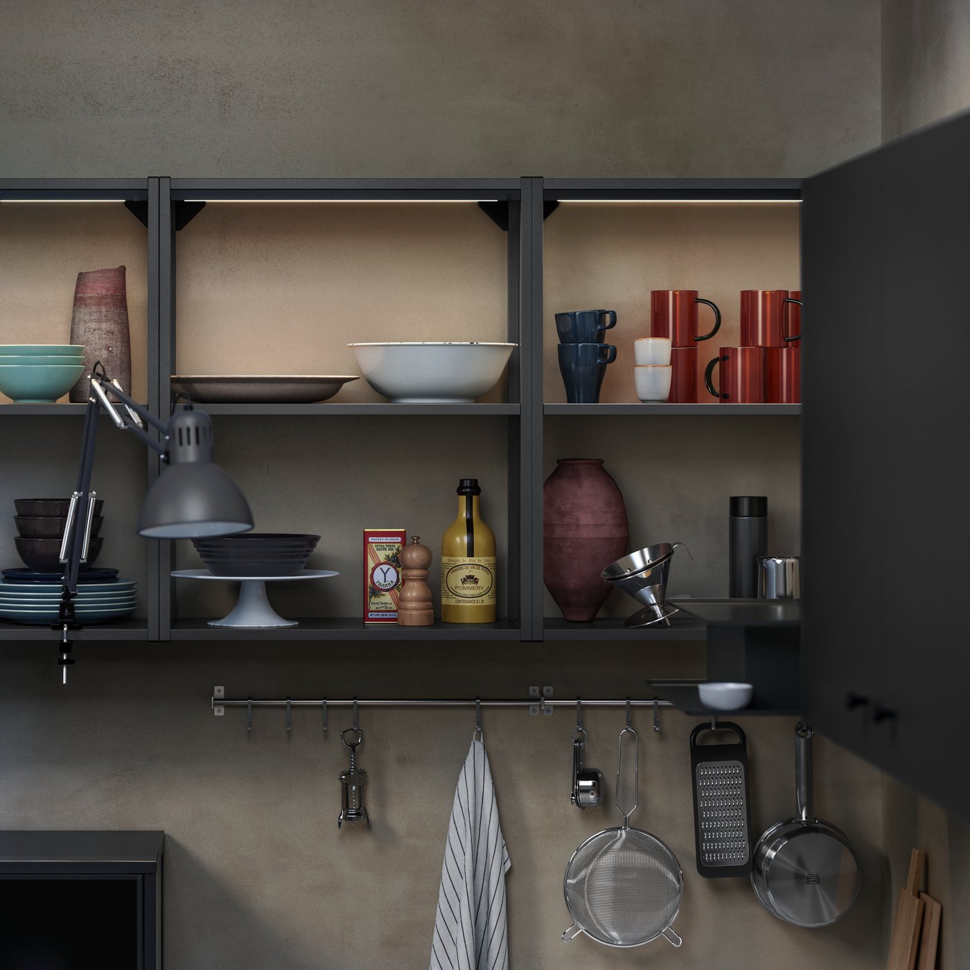 ENHET wall frame with shelves in anthracite with bowls, cups, and cooking essentials against a textured wall.
