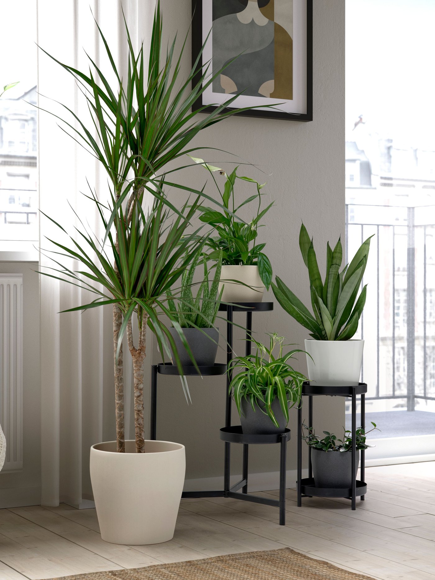 A black OLIVBLAD plant stand for indoors and outdoors.