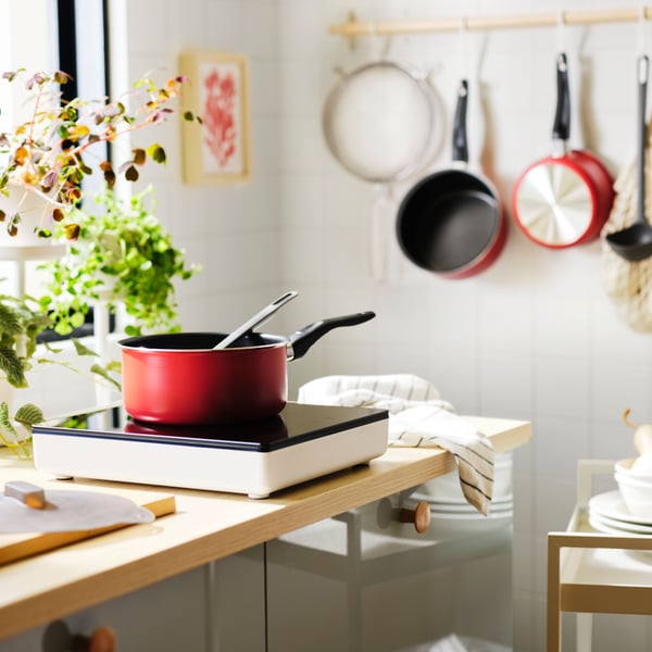 A red KAVALKAD saucepan