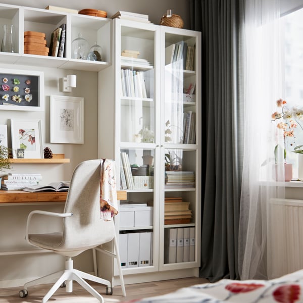 A white NYMÅNE wall/reading lamp in the home office