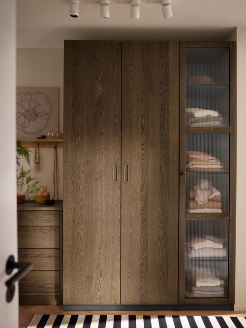 Bedroom featuring a beige PAX wardrobe combination, a white NYMÅNE ceiling spotlight with 4 spots and a PJÄTTERYD picture.