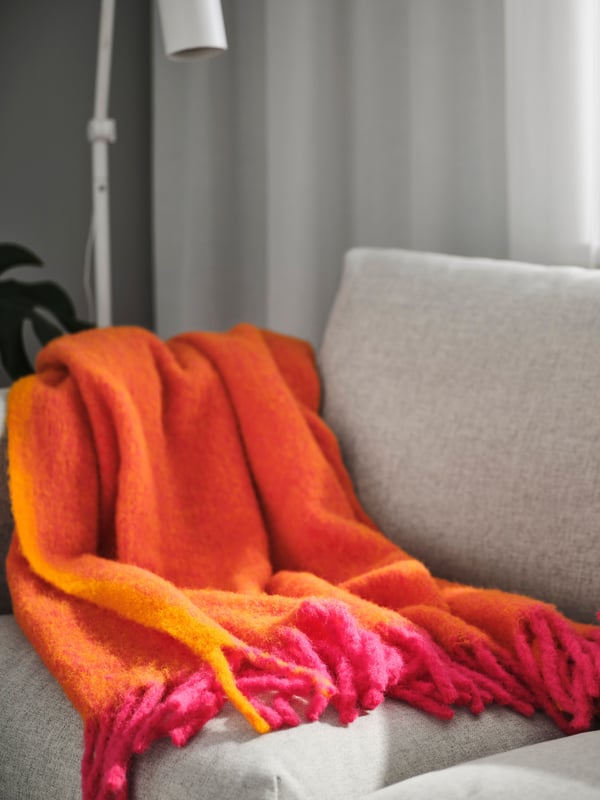 IKEA KLIPPOXEL orange/bright pink KLIPPOXEL throw on a sofa