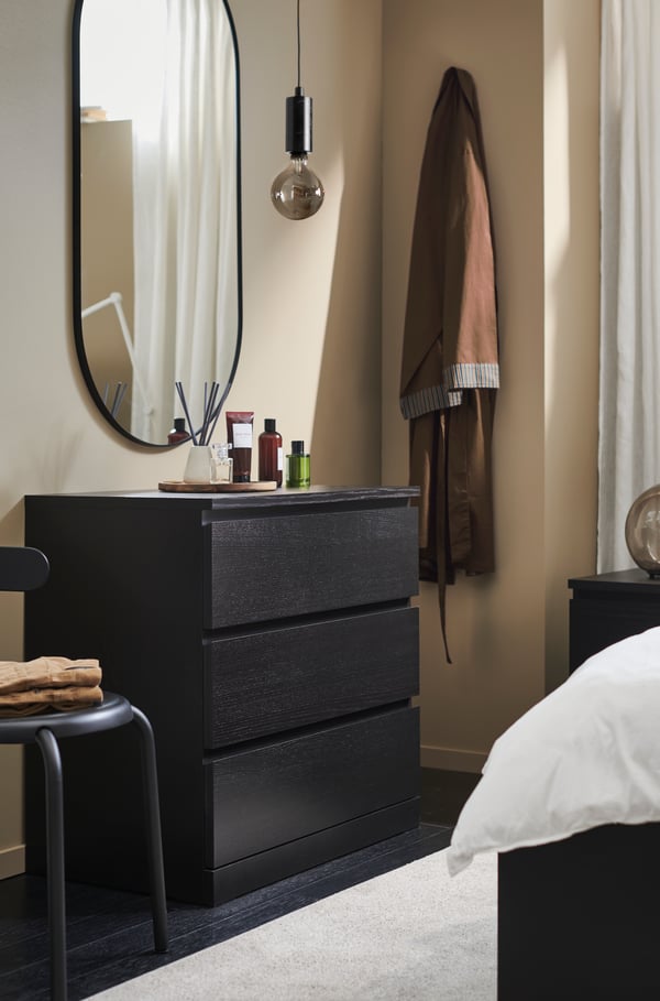 A black-brown MALM chest of 3 drawers