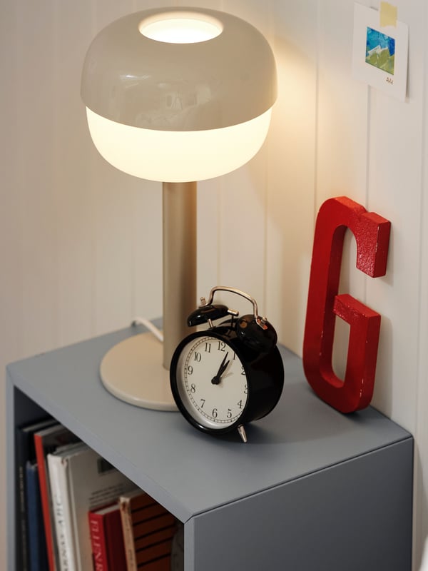 A light grey-blue EKET cabinet in the bedroom
