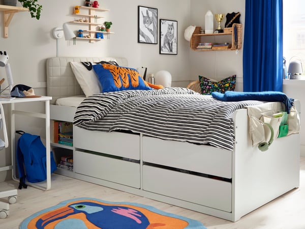A white SLÄKT bed frame with storage