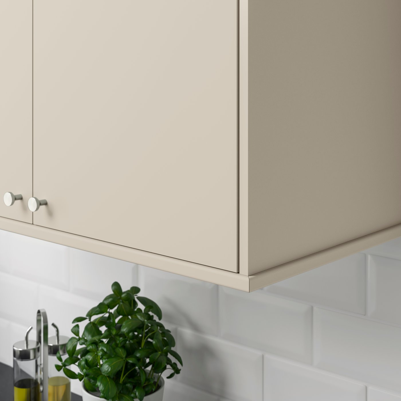 A beige HAVSTORP kitchen cabinet with rounded decorative moulding/profile.