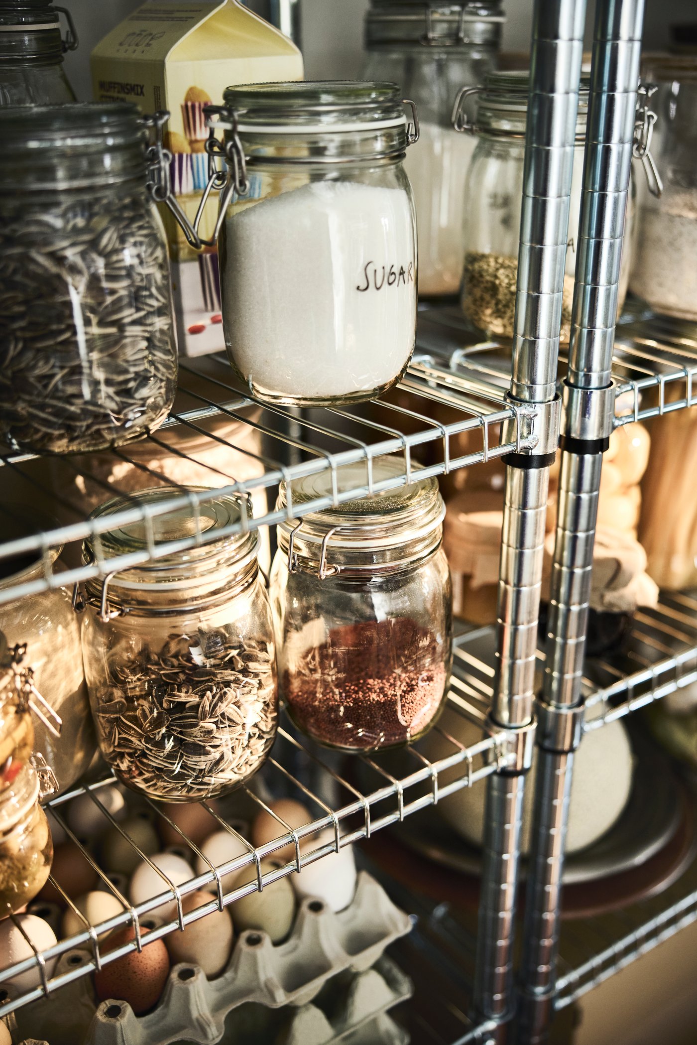OMAR shelving units store and organise dry food for an open pantry.