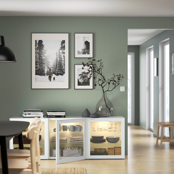 IKEA BESTÅ low white storage cabinet with three glass doors in a sage green dining room