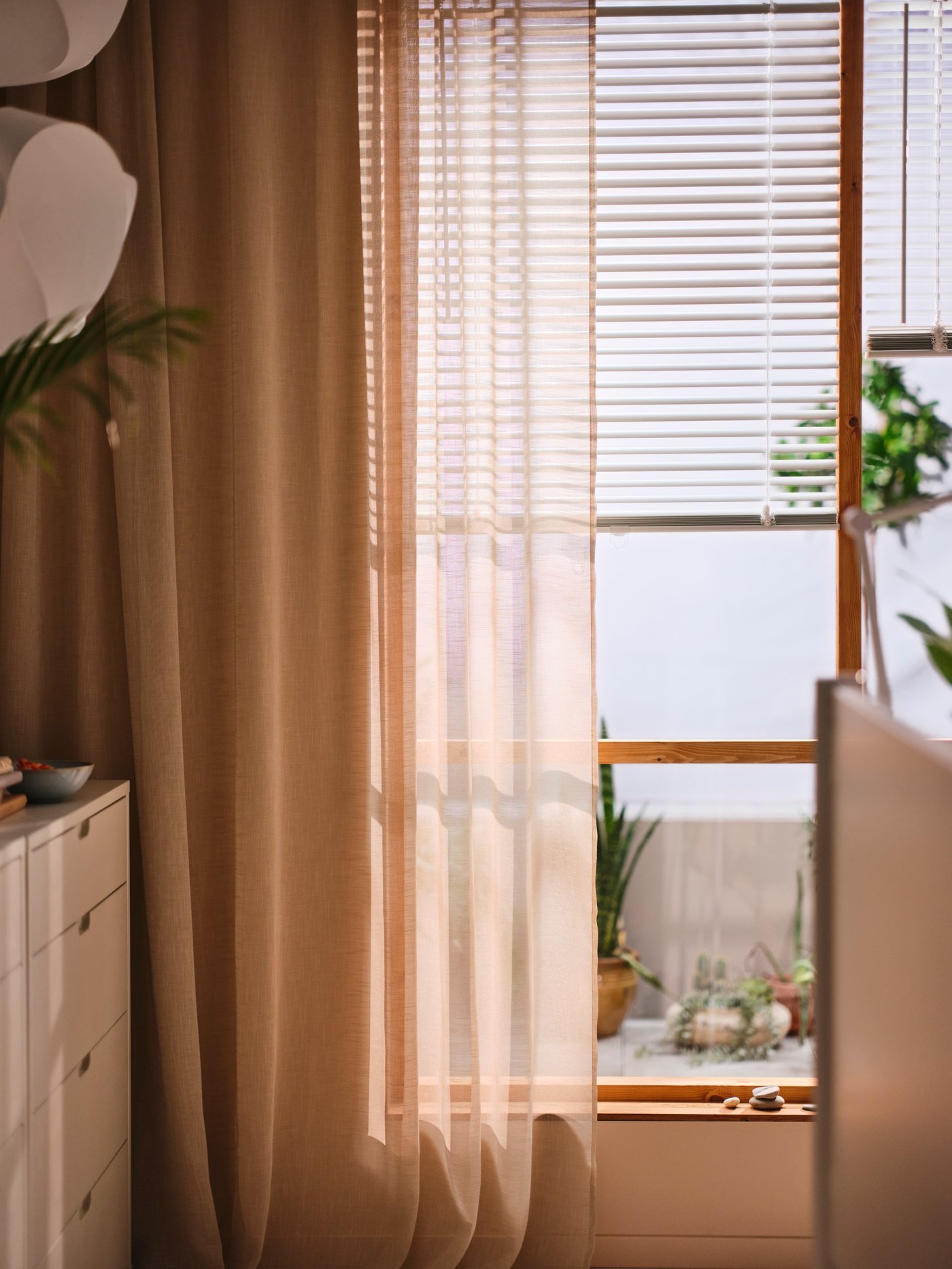 A white NYMÅNE floor/reading lamp in the bedroom