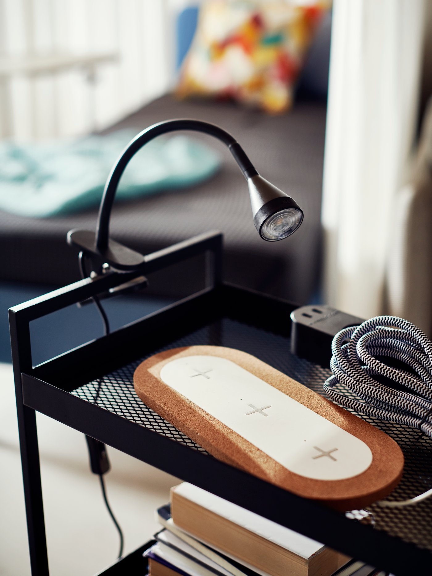 A black NÄVLINGE LED clamp spotlight