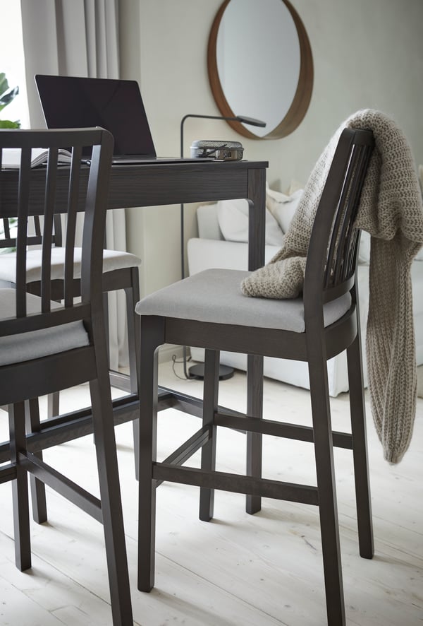 A dark brown/Orrsta light grey EKEDALEN bar stool with backrest in the dining room