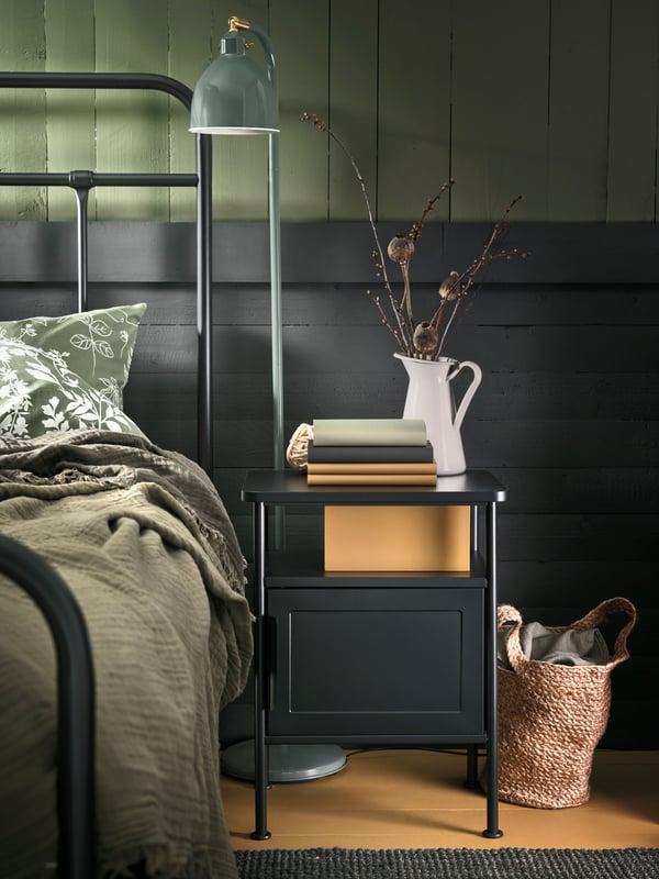 A grey-green VALLKRASSING throw in the bedroom