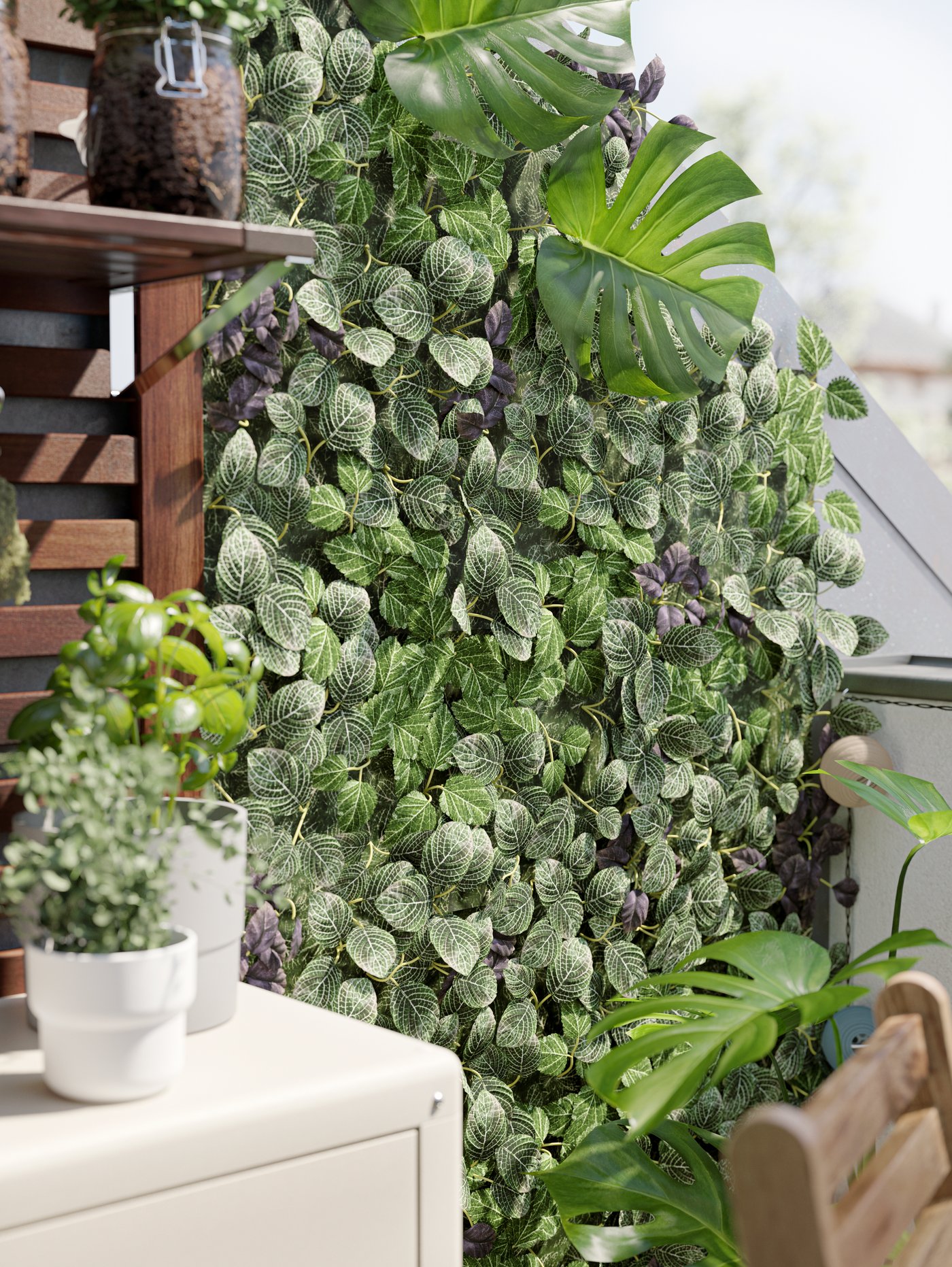 A wall on the balcony covered with green artificial plants, a beige cabinet, wall panel, plants in white pots.