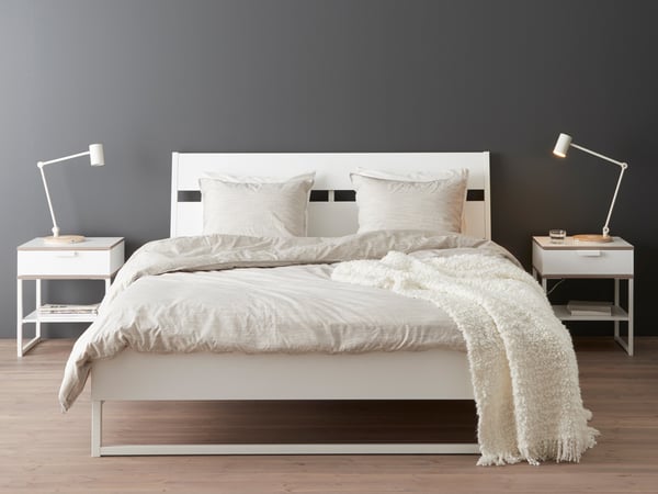 A white/light grey TRYSIL bedside table in the bedroom
