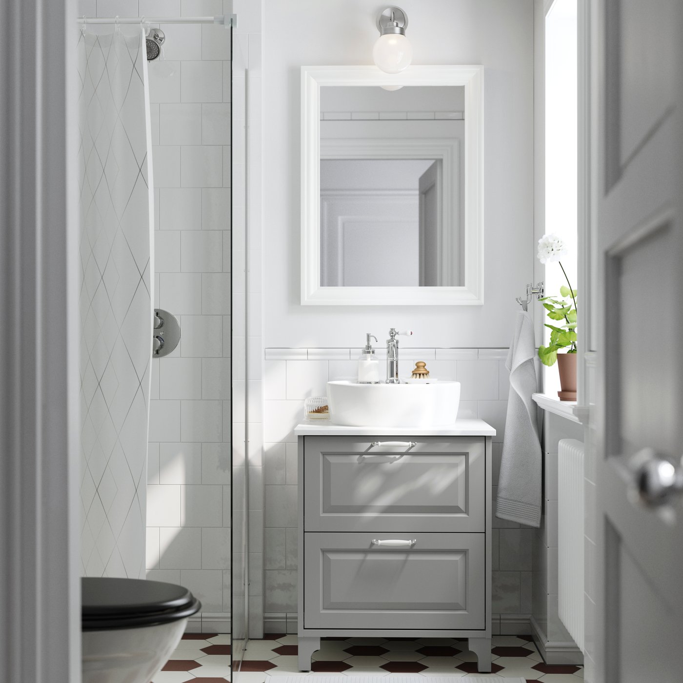A light grey/white marble effect TÄNNFORSEN wash-stnd w drawers/wash-basin/tap in the bathroom
