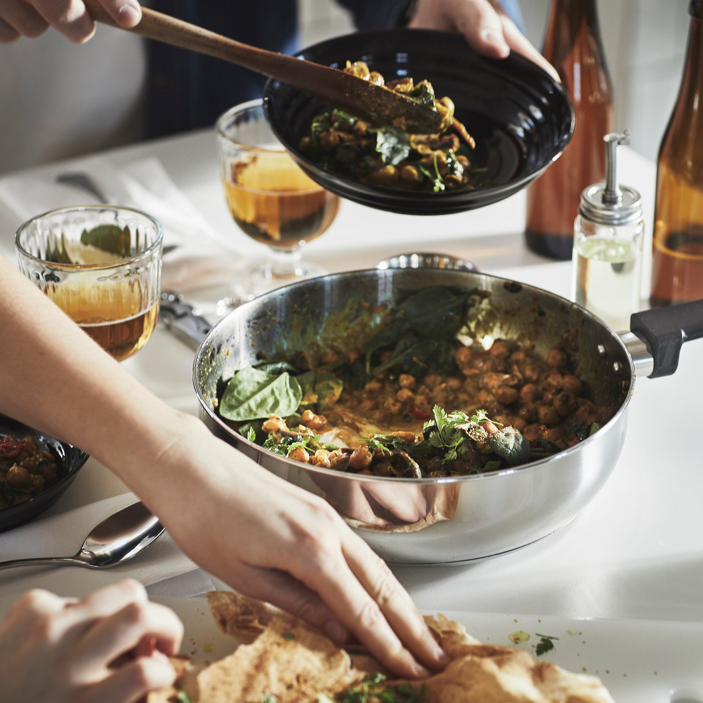 A clear glass/stainless steel MIDDAGSMAT sauté pan with lid