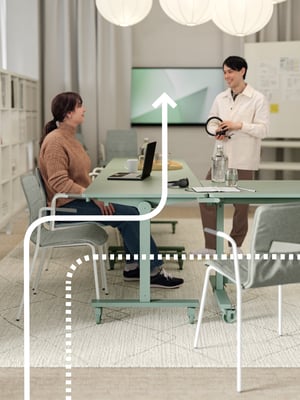 To kollegaer diskuterer over et møtebord.