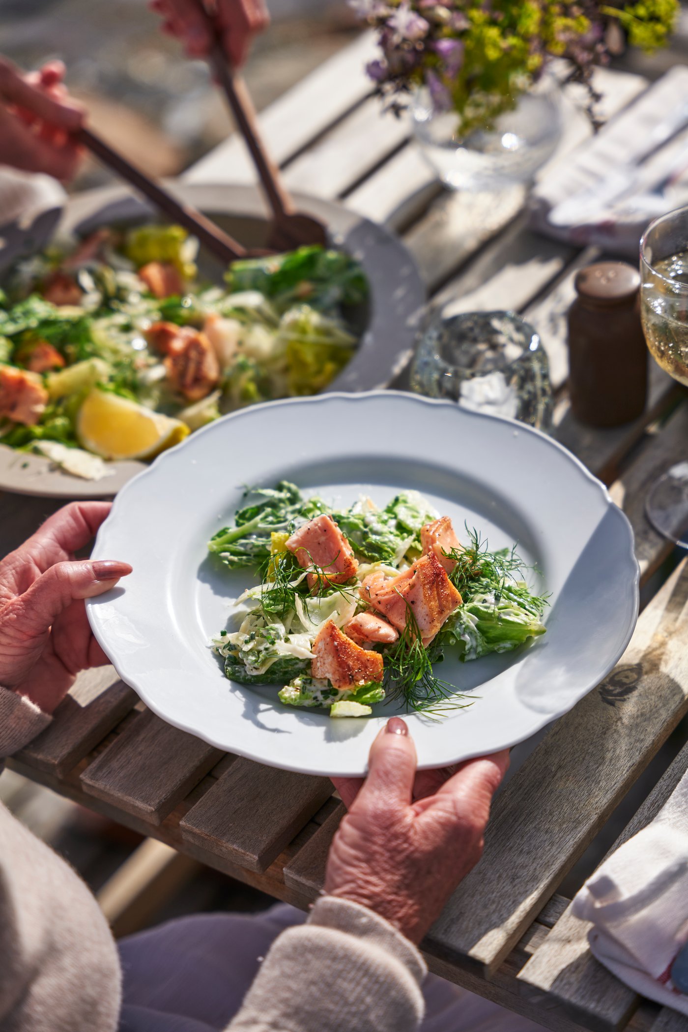 SJÖRAPPORT salmon fillet served on a UPPLAGA white plate with salad. 