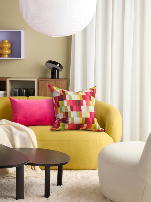 A multicolour LÖVNATURSKOG cushion cover in the living room