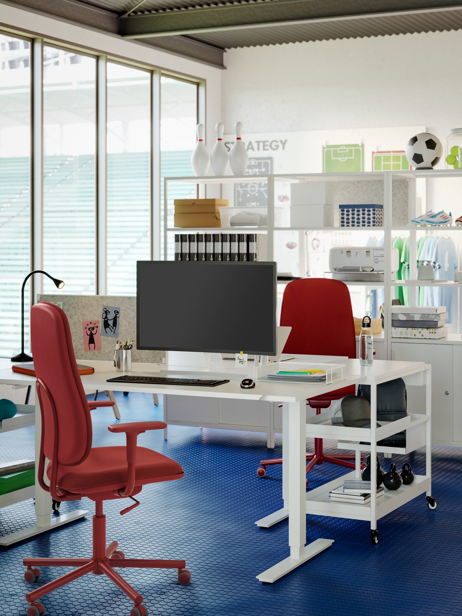 A workstation with two white TROTTEN desks opposite each other, two red SMÖRKULL chairs in an open and sporty office space.