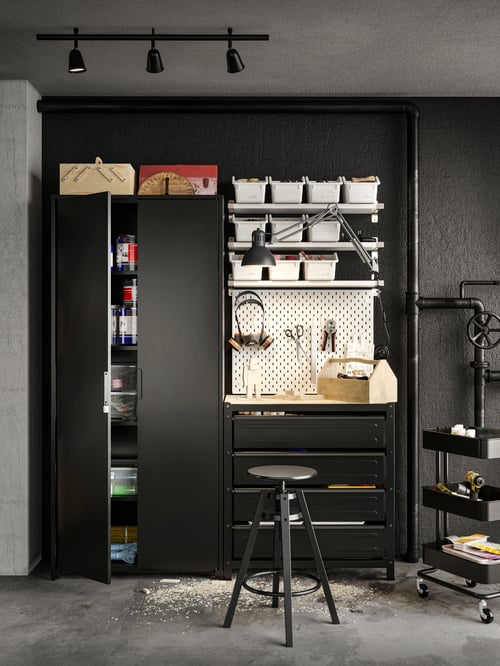 Workspace featuring a black BROR shelving unit with cabinets drawers, a black RÅSKOG trolley and a SKÅDIS pegboard.