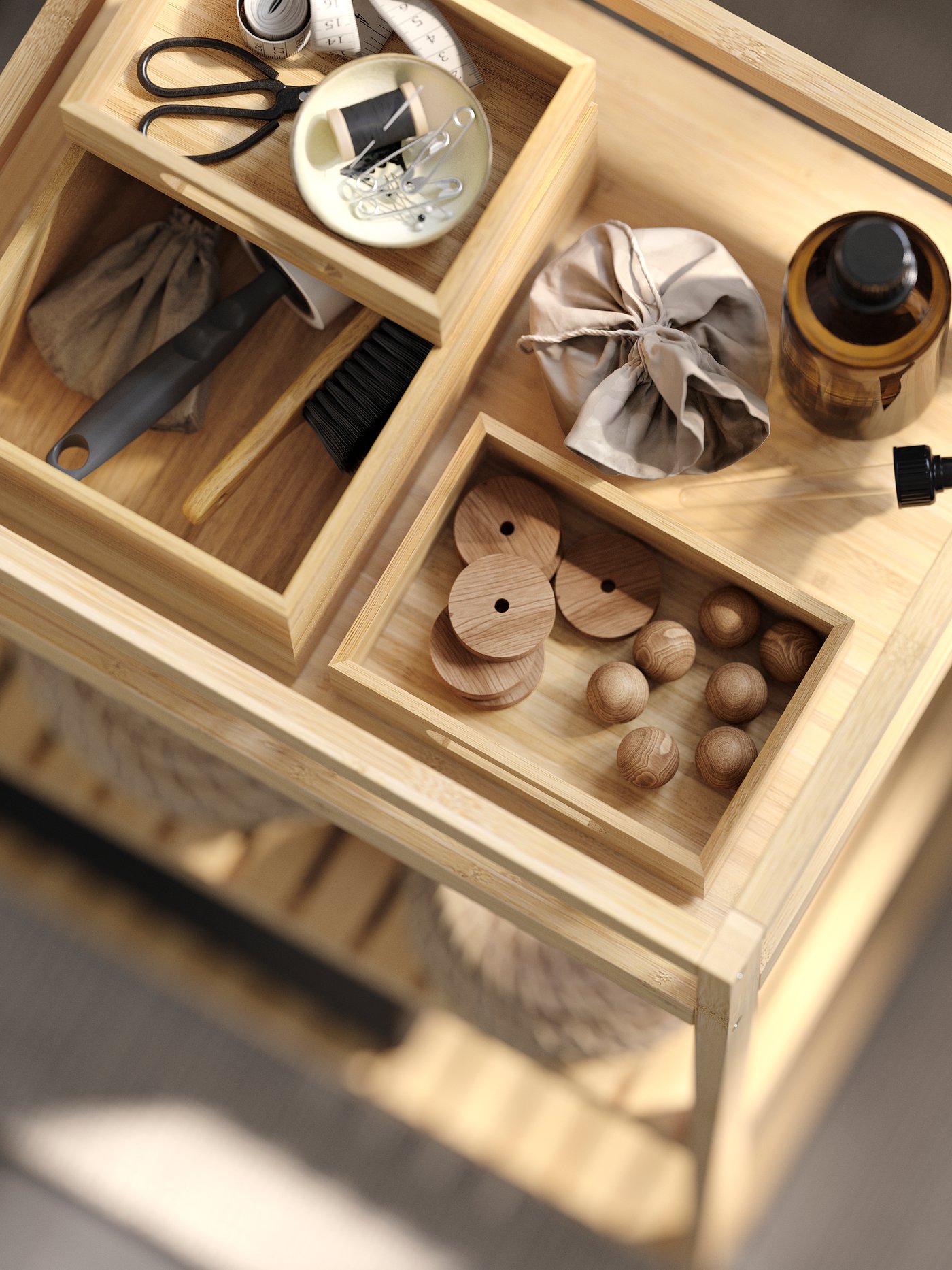 Three DRAGAN boxes in natural bamboo filled with sewing kit and small things, places inside RÅGRUND bamboo shelf.