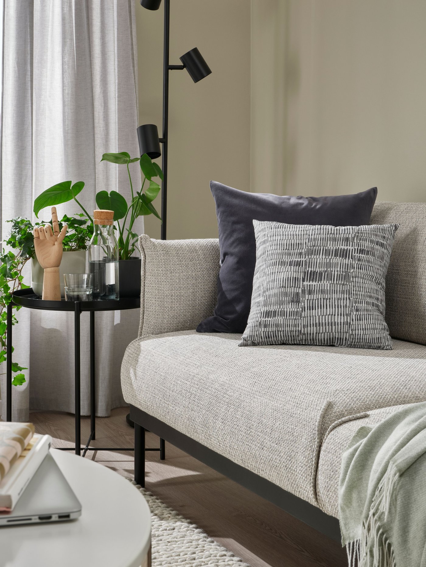 A dark grey SANELA cushion cover