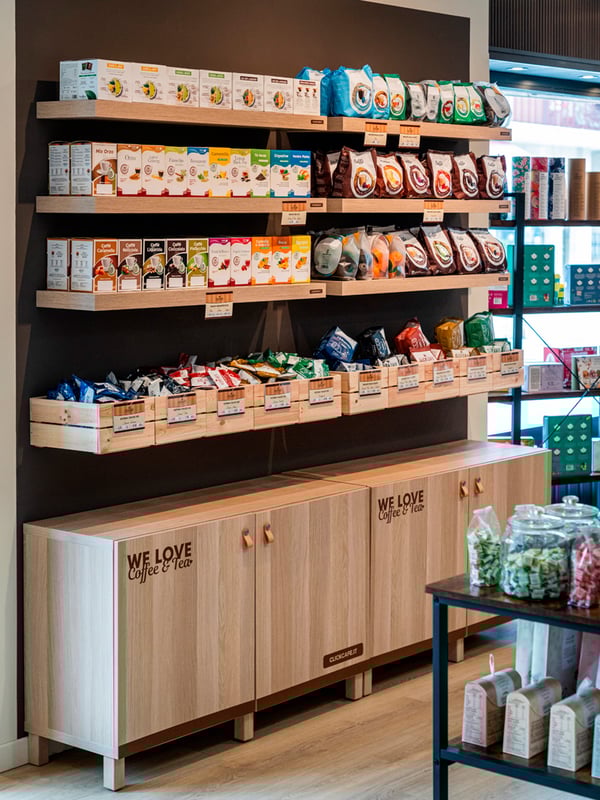 Interno di un Click Cafè con prodotti, arredato con soluzioni IKEA BESTÅ con ante LAPPVIKEN, gambe STUBBARP, mensole LACK e contenitori KNAGGLIG.