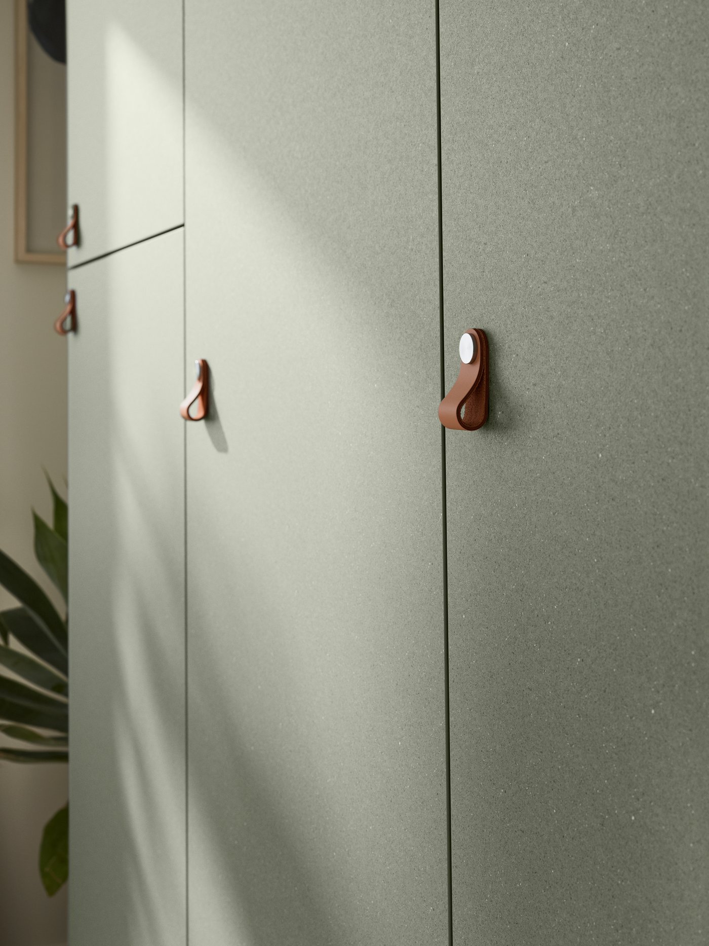 A grey-green KLUBBUKT door in the bedroom