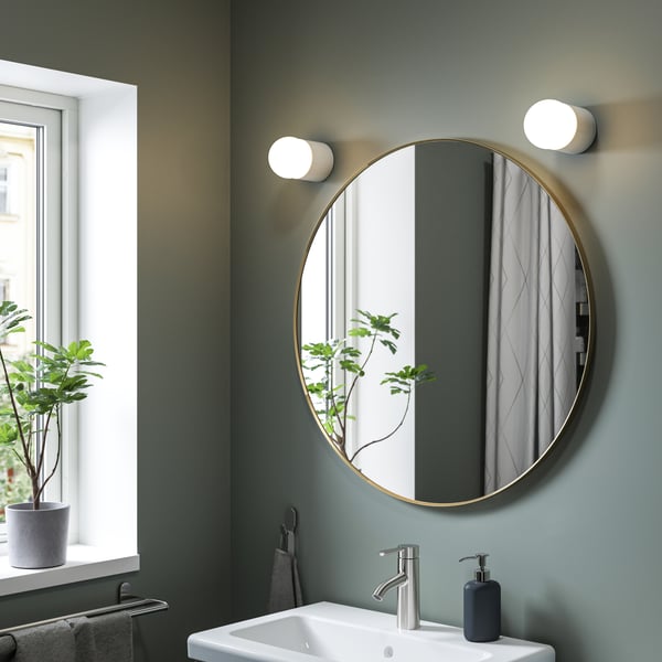 A gold-colour round LINDBYN mirror in the bathroom.