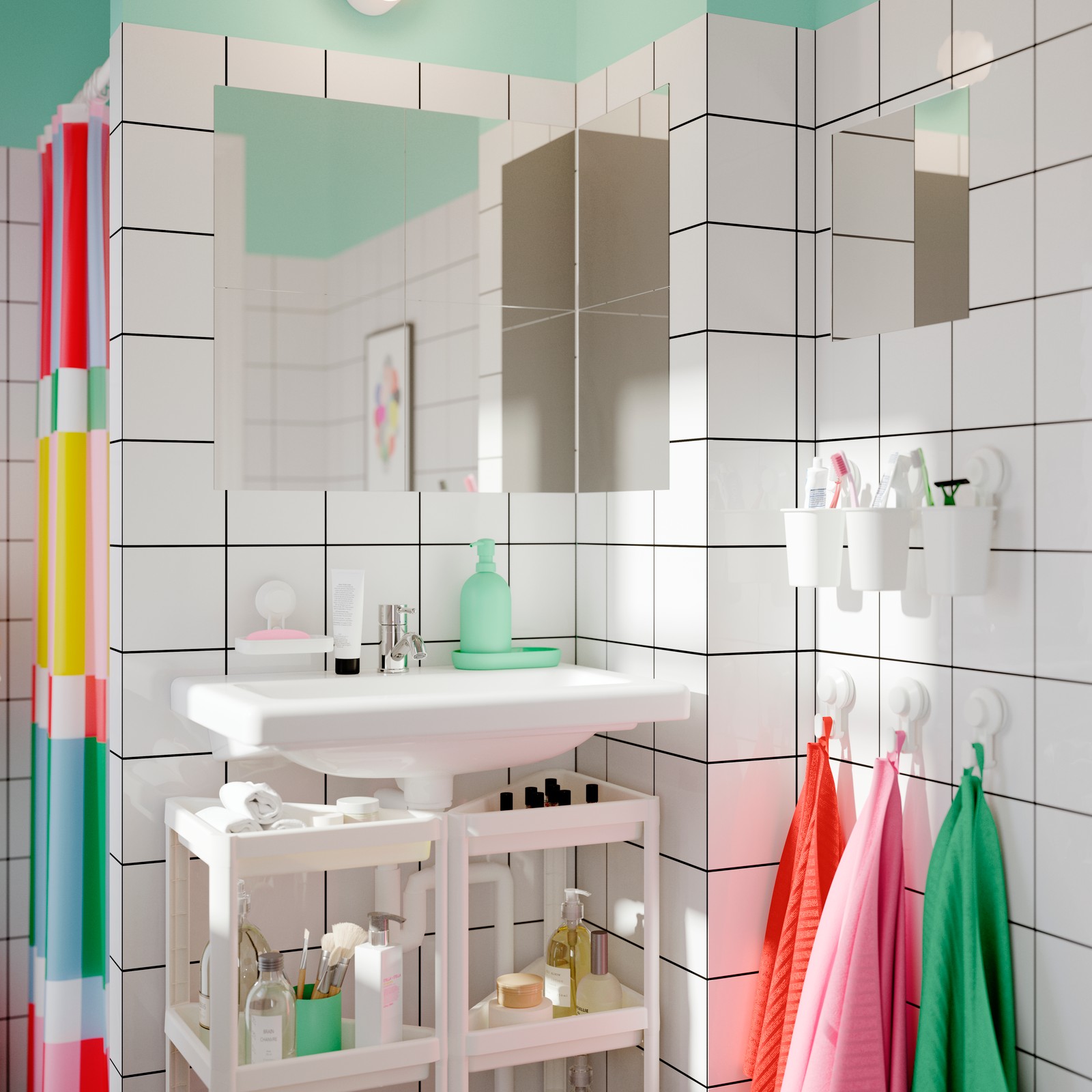 Two VESKEN corner shelf units filled with toiletries, are under a sink in a bathroom. Colourful towels hang on the wall.