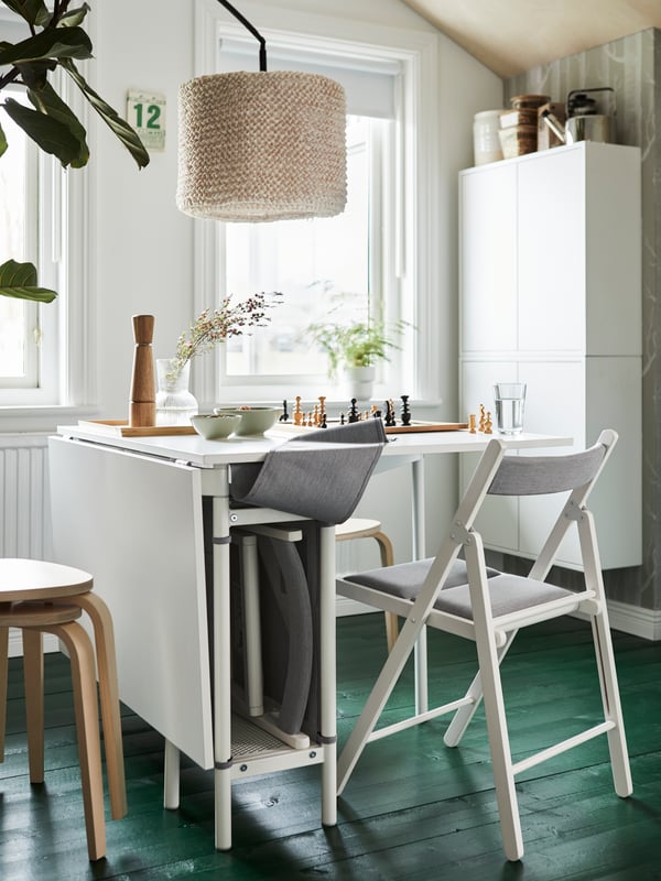 A white/light grey KALLHÄLL gateleg table with storage
