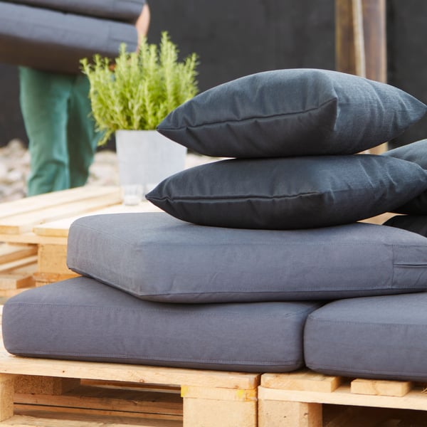Stack of FRÖSÖN outdoor cushions.