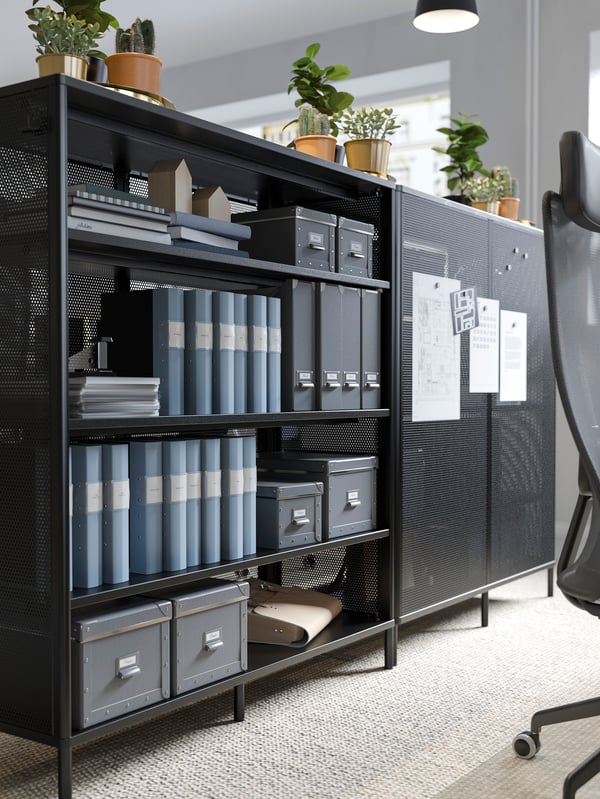 A dark grey FJÄLLA storage box with lid in the home office